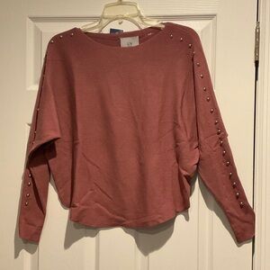 LIV sweater with grommets n the sleeves.